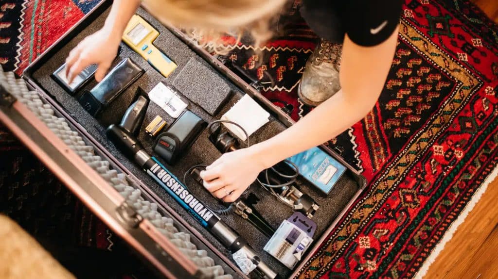 Woman opening water damage tool kit on jobsite