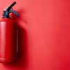 Fire extinguisher with red background